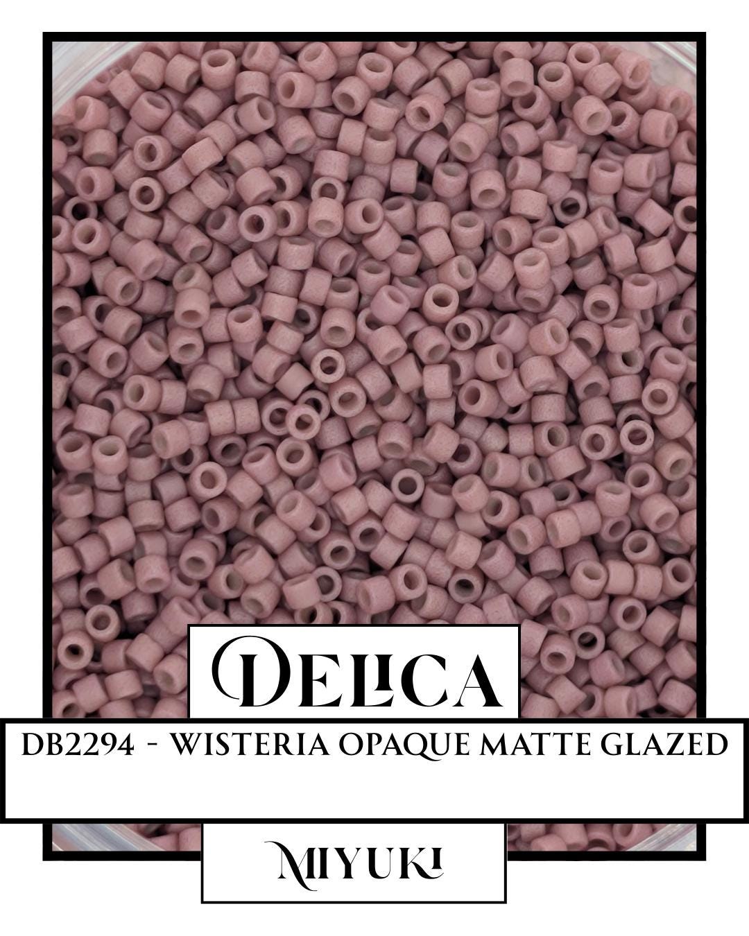 The image is a close-up of a large pile of pink, glazed beads or beads, possibly made of plastic or glass.