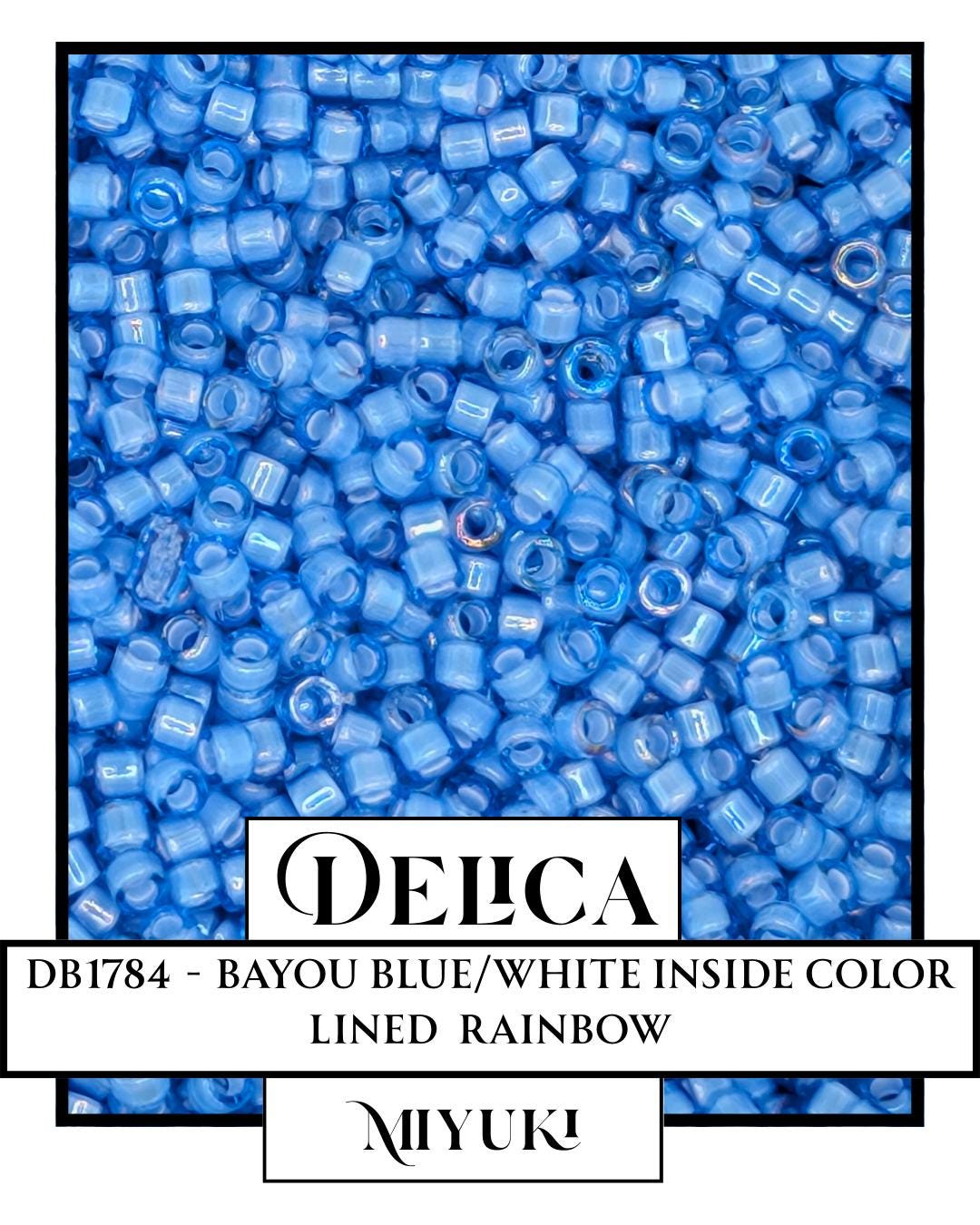The image is a close-up of a large pile of blue beads or beads in a white background.
