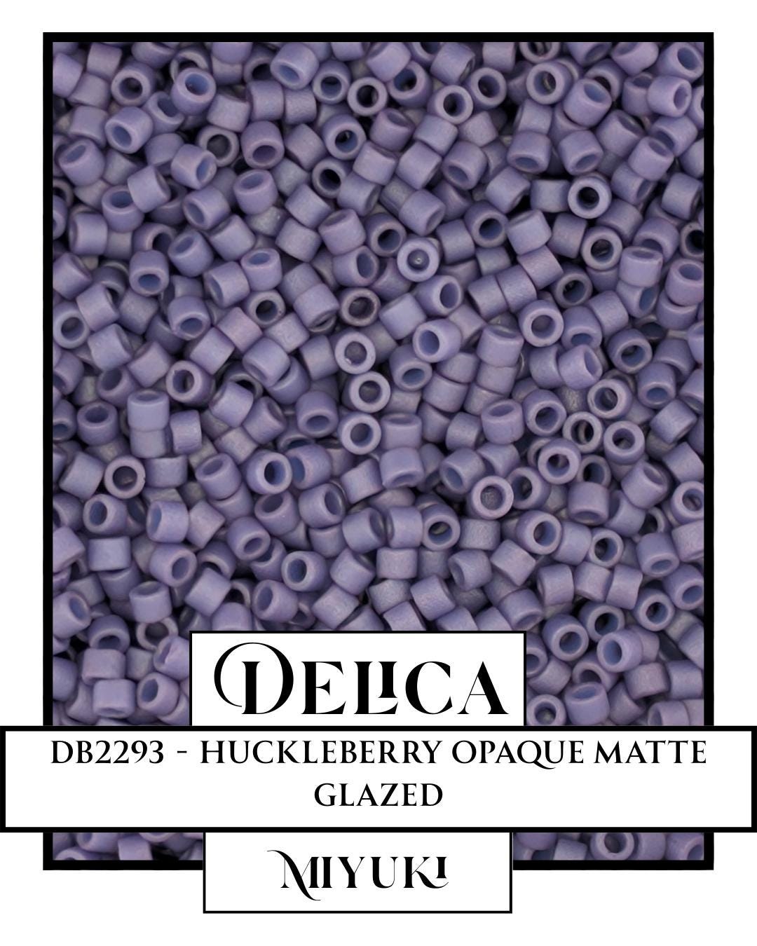 The image is a collage of multiple images featuring a large number of small, round beads in various shades of purple. The text in the image includes the name "DELLA" and the product information "DB2393 - HUCKLEBERRY OPAQUE MATTÉ GLAZED".