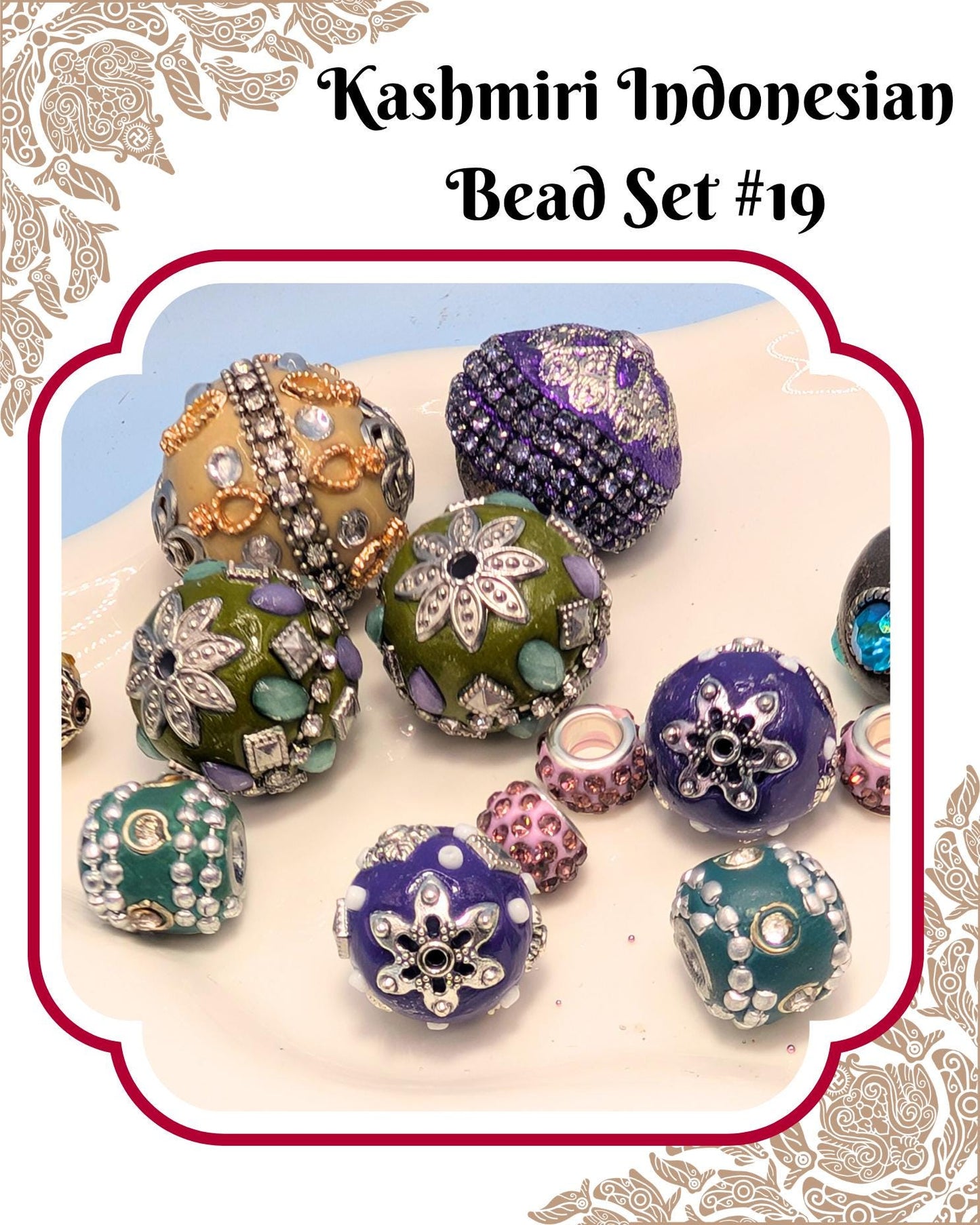 A collection of colorful, intricately designed beads in various shapes and sizes, including round, oval, and star-shaped pieces, arranged on a white surface.