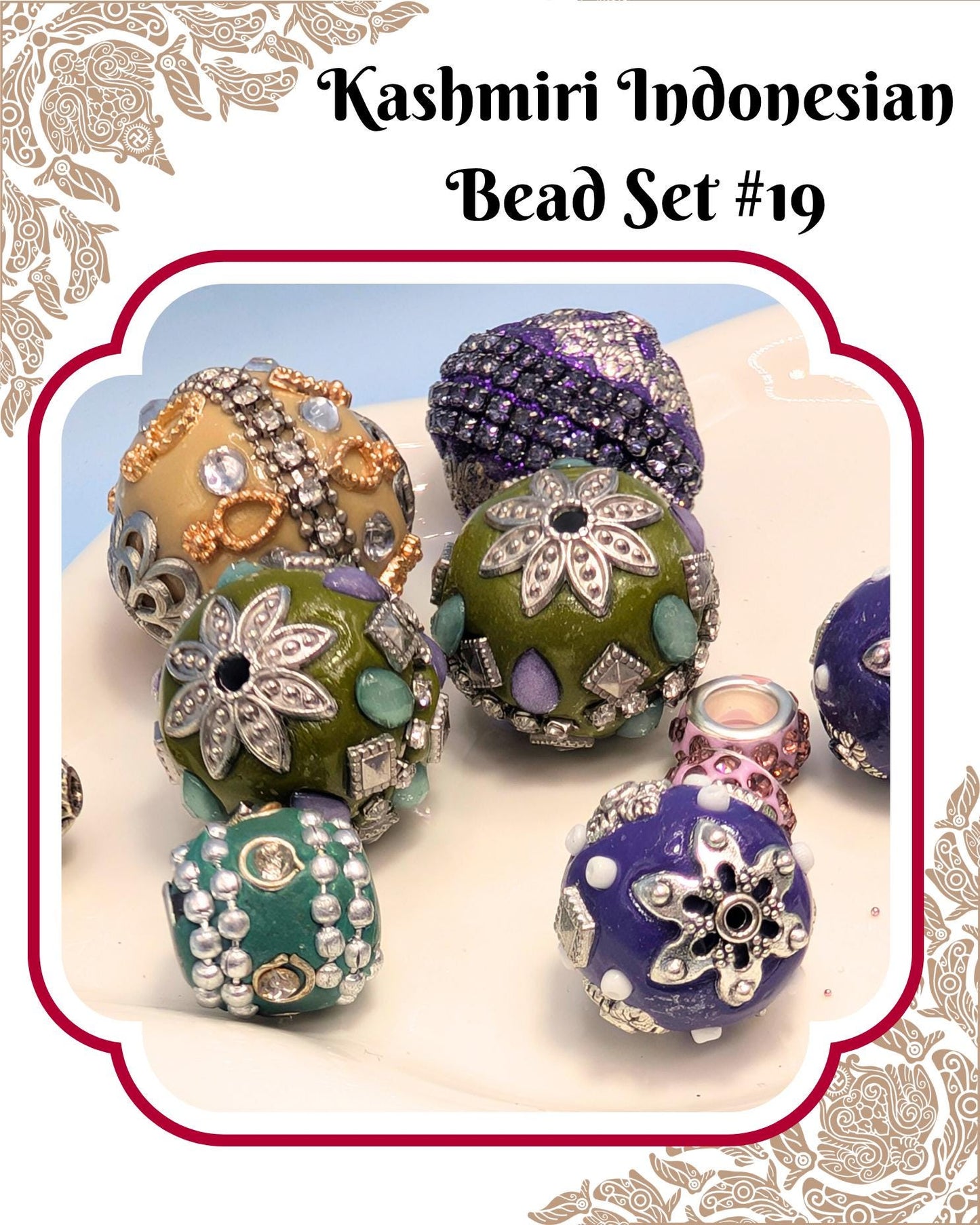 A collection of colorful, intricately designed beads in various shapes and sizes, including round, oval, and star-shaped pieces, arranged on a white surface.