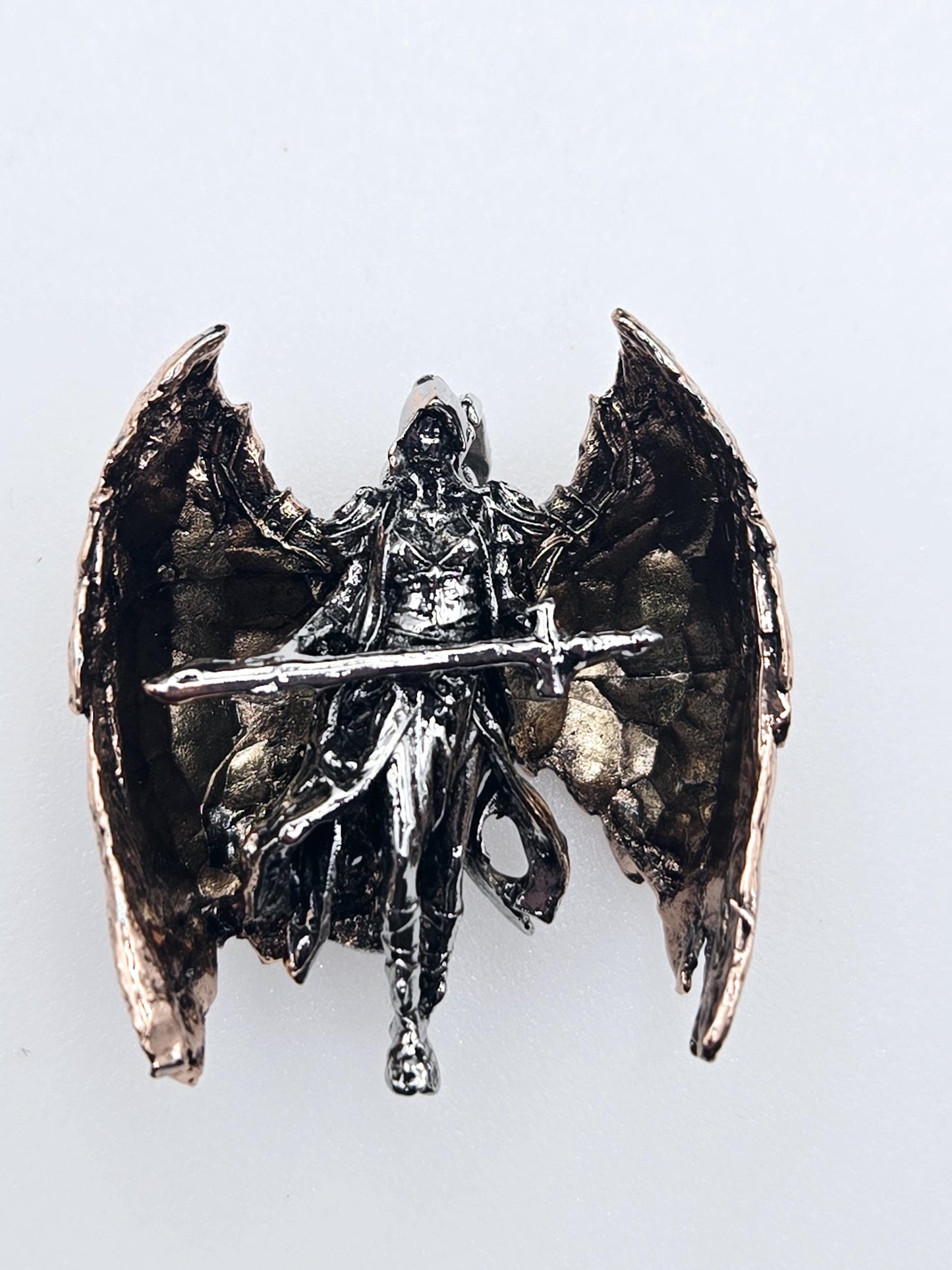 A metallic, sculpted piece with a twisted, metallic appearance, resembling a metallic bird or winged creature.