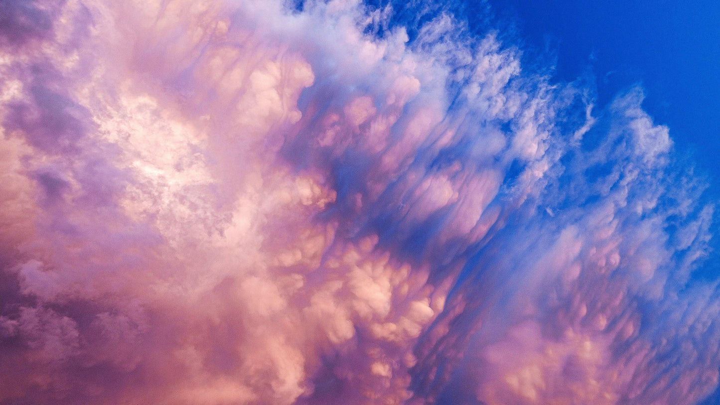 a stunning sky filled with vibrant pink and blue clouds, creating a captivating and visually striking scene.