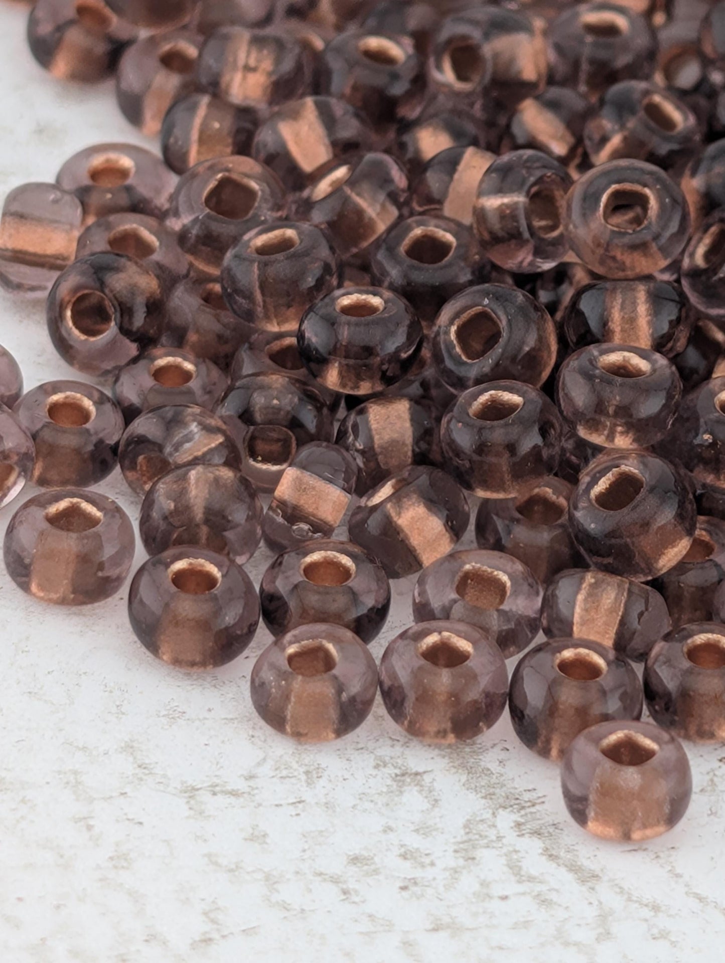 Transparent Copper-Lined Amethyst Size 11/0 15g pkg