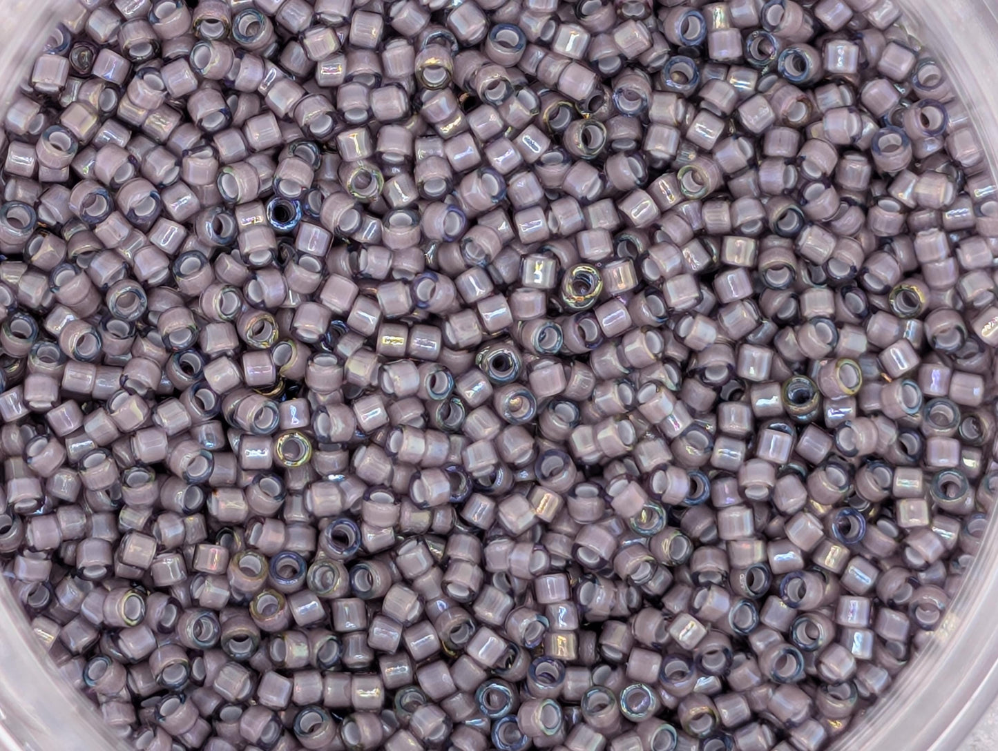 A close-up image of a large pile of small, round beads in various shades of gray.