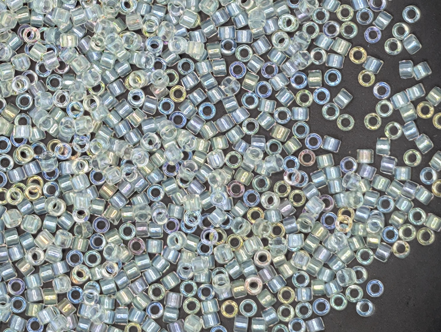 numerous small, clear beads scattered across a dark background.