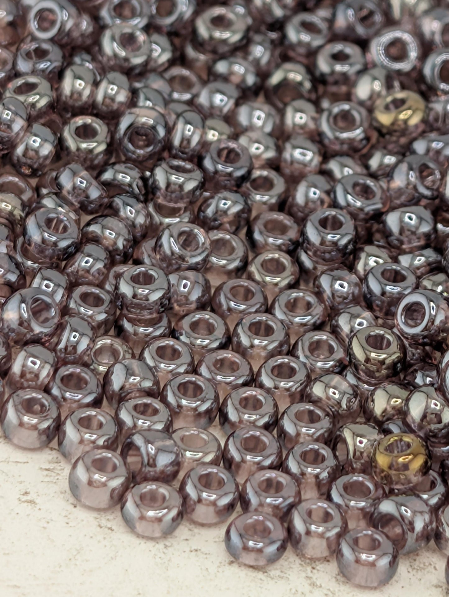 a close-up view of numerous small, shiny beads scattered across a surface.