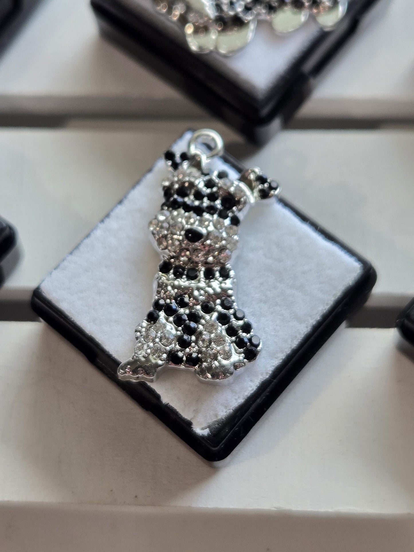 A close-up image of a decorative piece with a black and silver design, featuring a diamond-shaped element with a black and silver pattern.