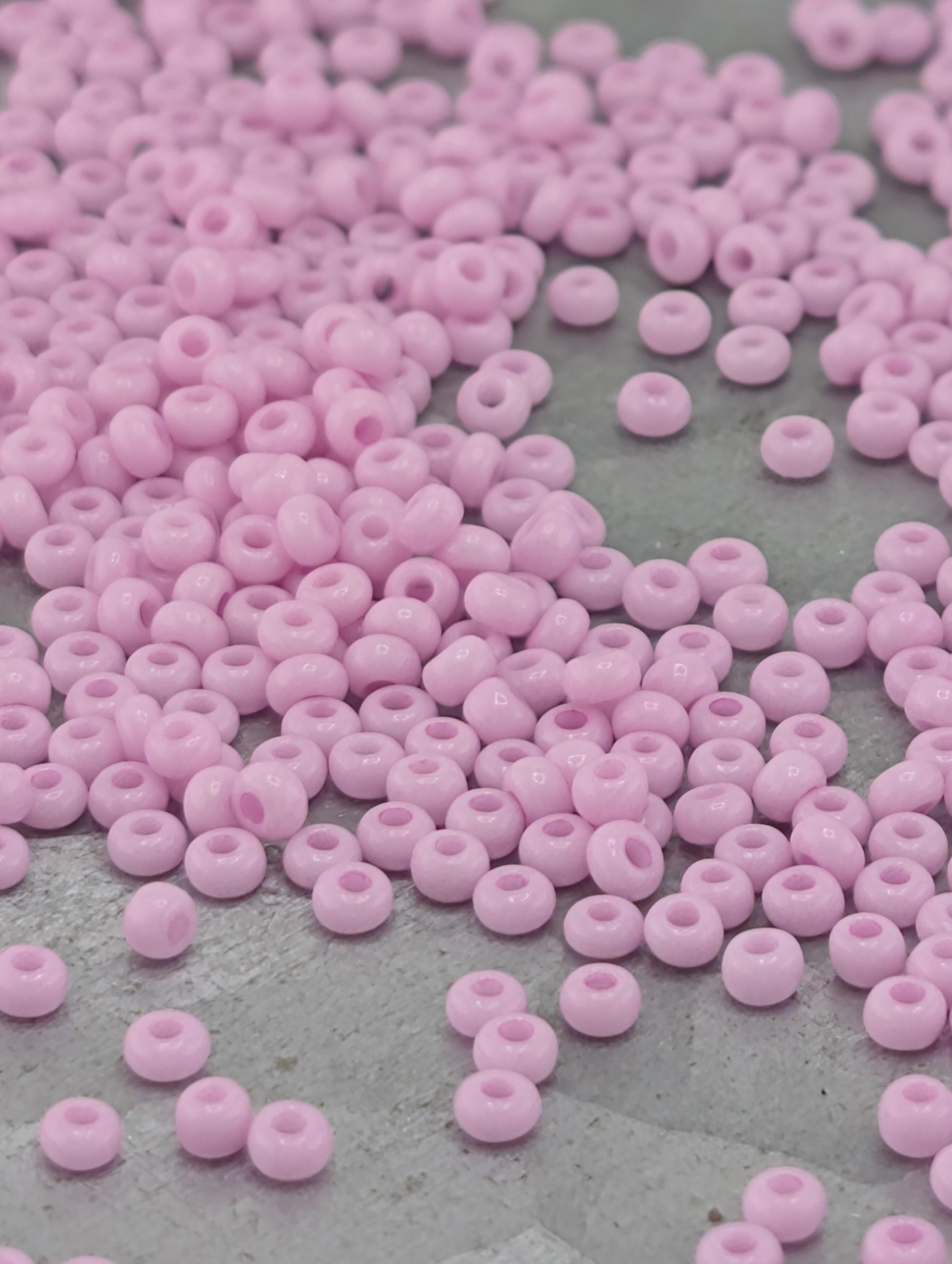 a close-up view of numerous small, round, pink beads scattered across a surface.