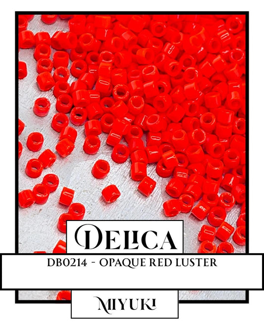 a large pile of red beads or beads, possibly made of glass or plastic, scattered on a white surface.