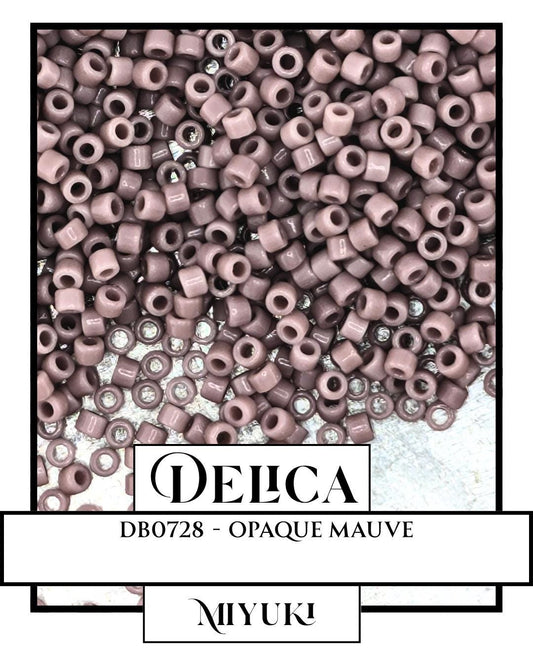 The image is a close-up of a large pile of small, round beads in various shades of pink, with the text &quot;DELCA&quot; and &quot;Miyuki&quot; visible.