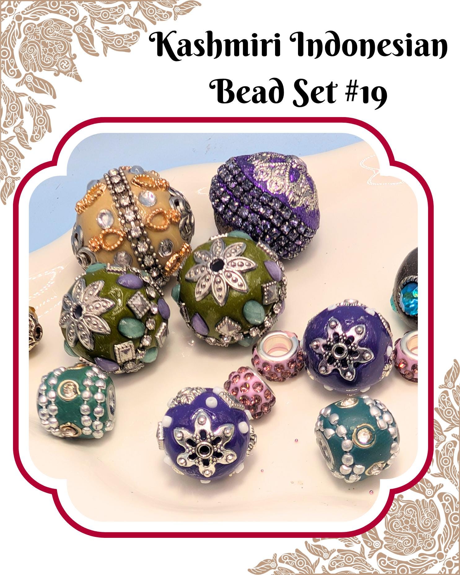 A collection of colorful, intricately designed beads in various shapes and sizes, including round, oval, and star-shaped pieces, arranged on a white surface.