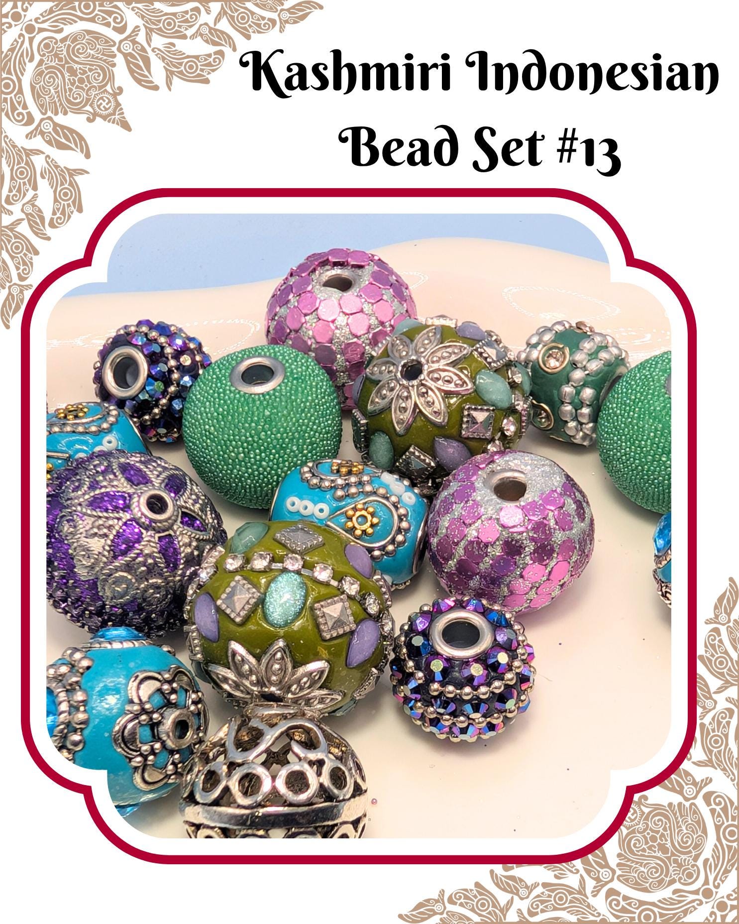 a collection of colorful beads, including green, purple, and blue beads, arranged on a white surface.