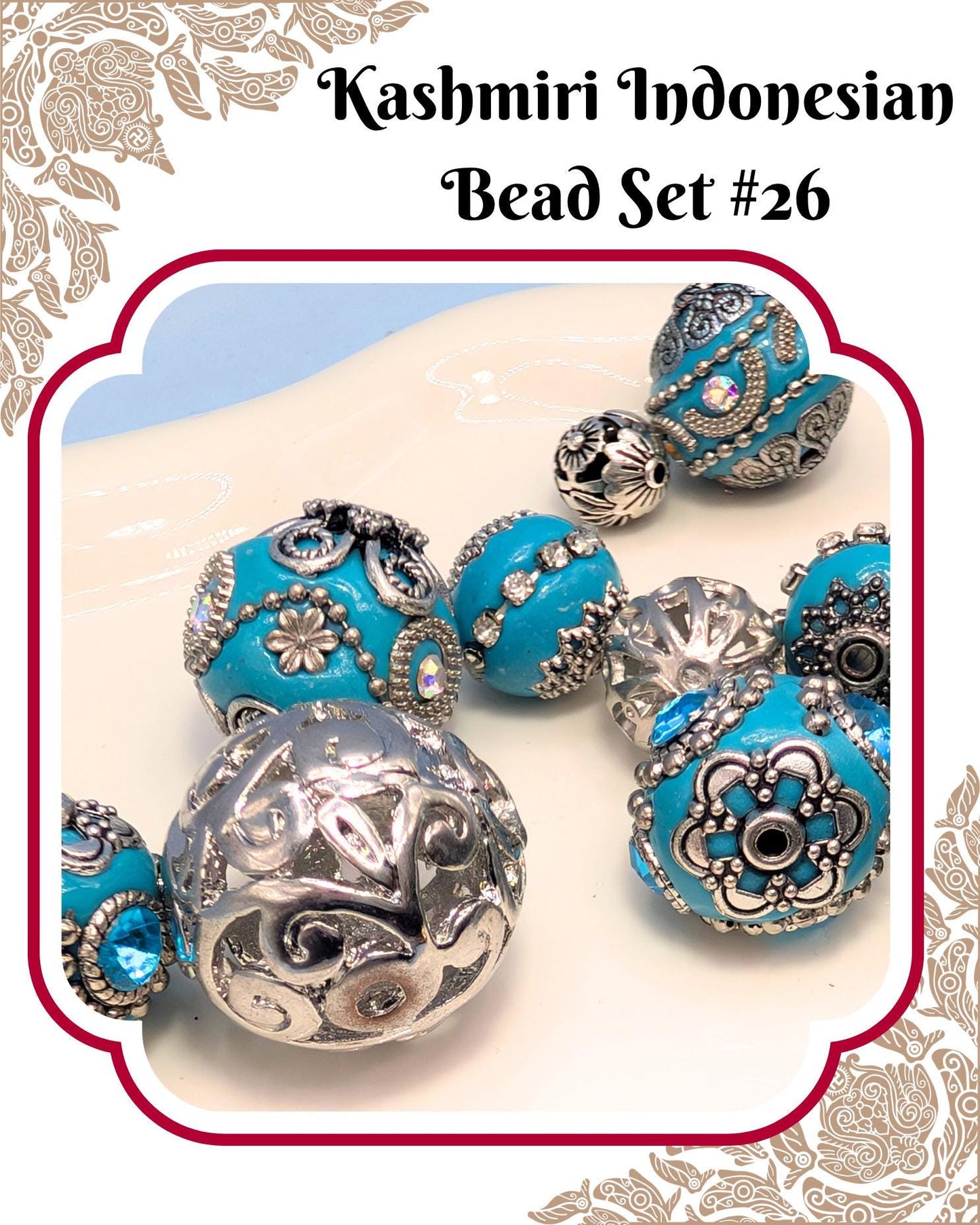 A collection of intricately designed blue and silver beads, including some with floral patterns, arranged on a white surface.