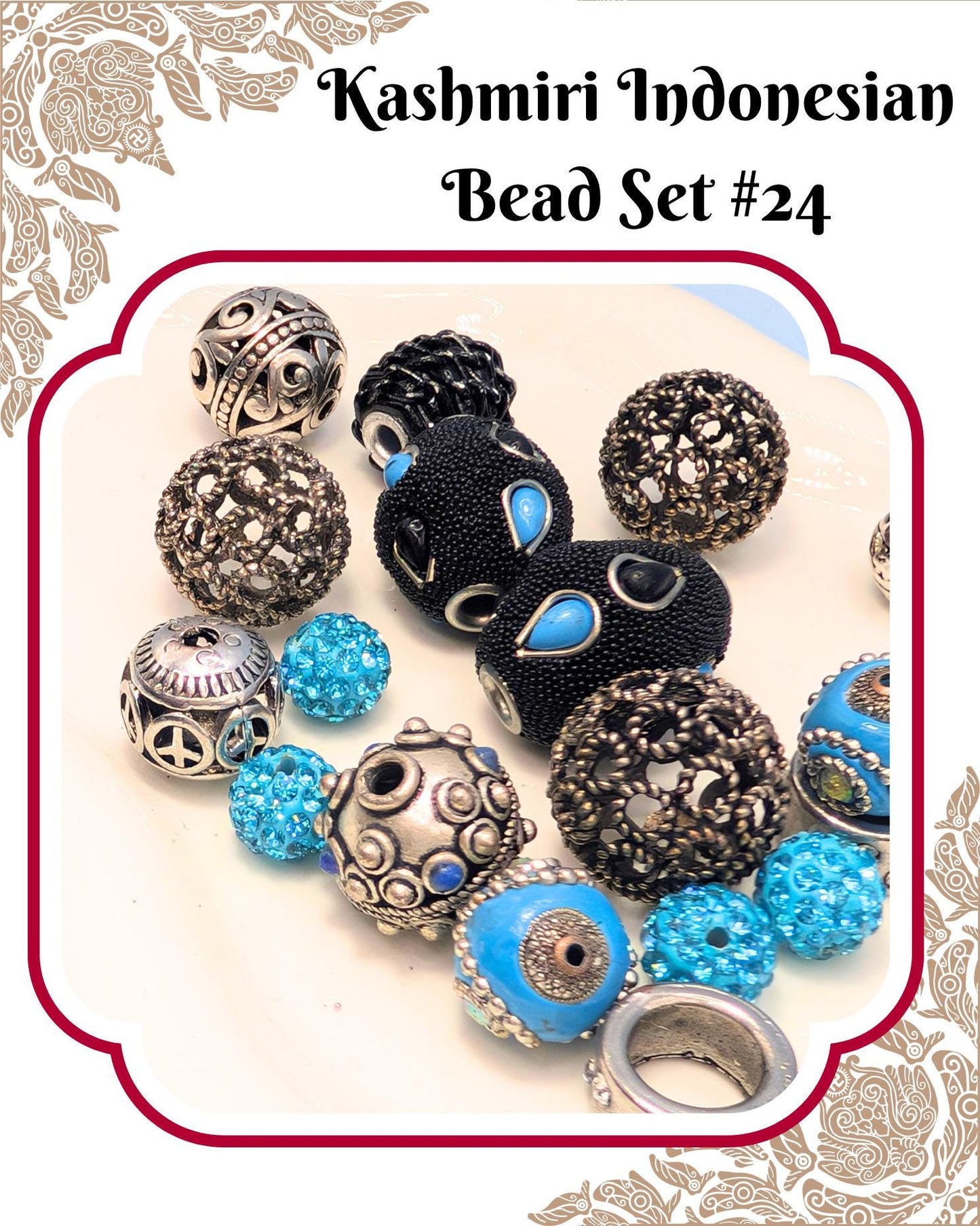 A collection of colorful beads, including silver, blue, and black beads, arranged on a white background.