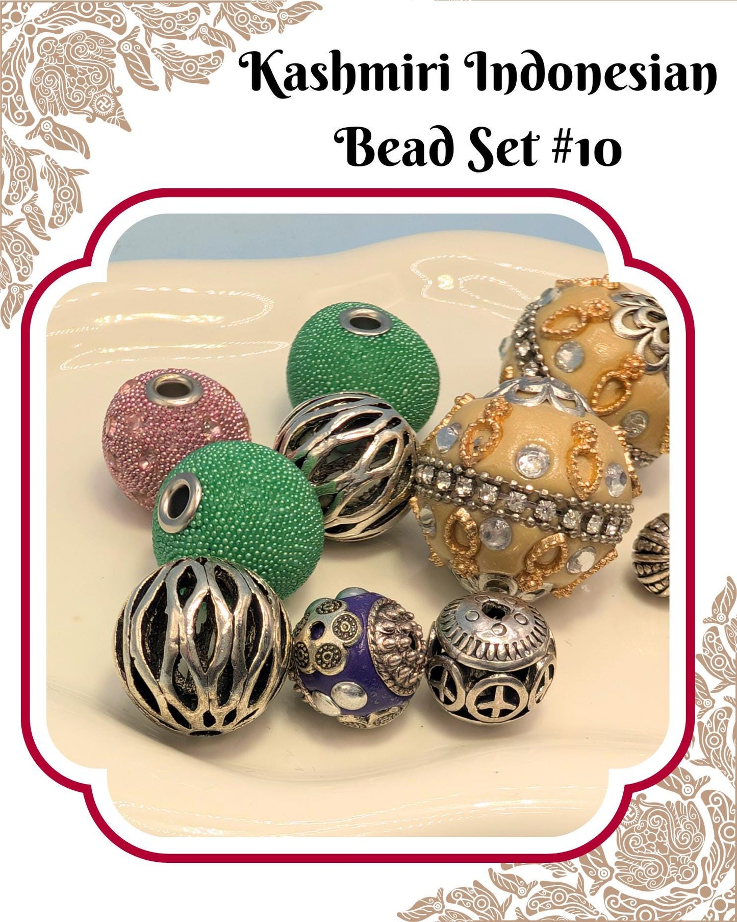 A collection of colorful beads, including green, silver, and gold-colored beads, arranged on a white surface.