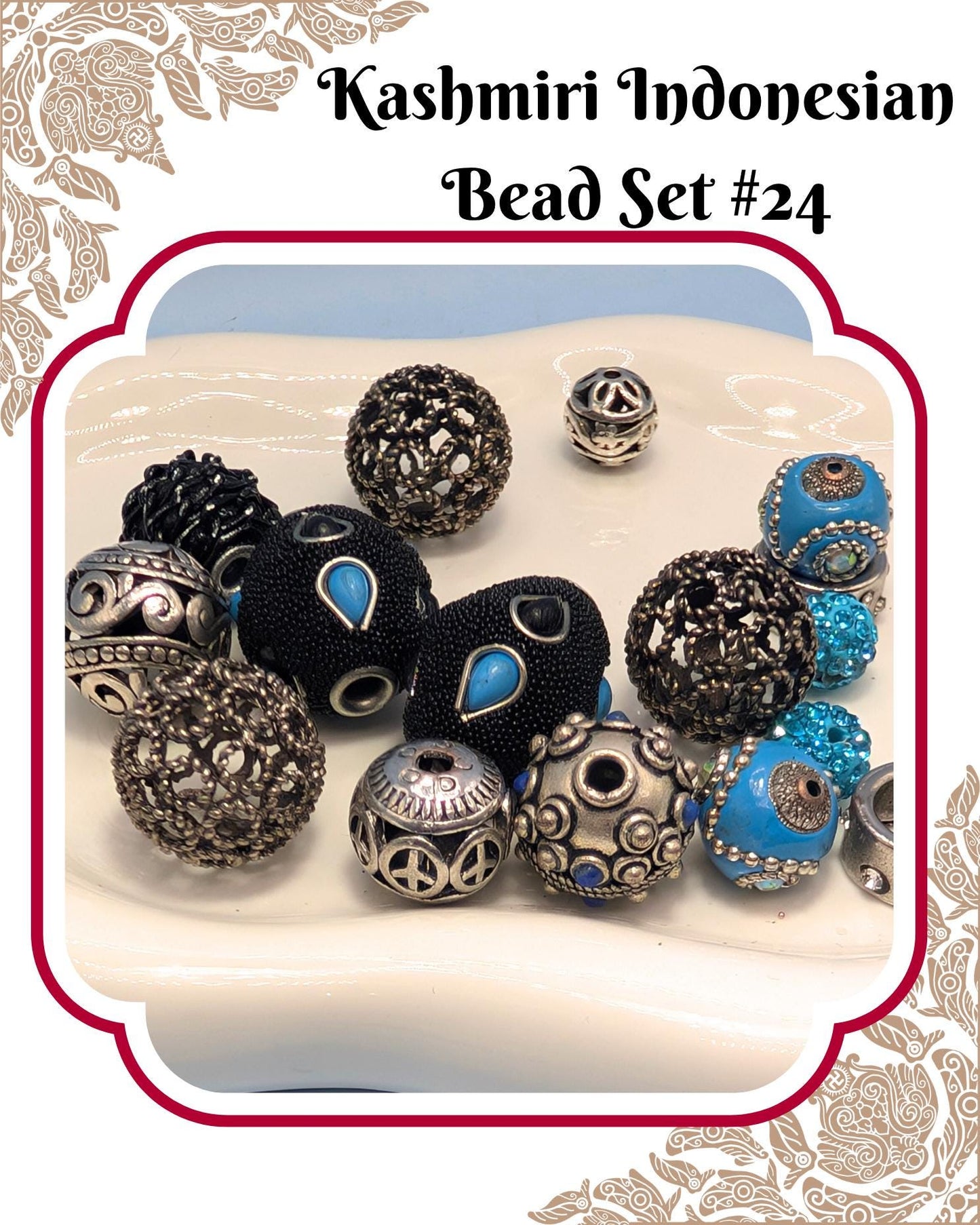 A collection of various beads, including black, blue, and silver beads, arranged on a white surface.