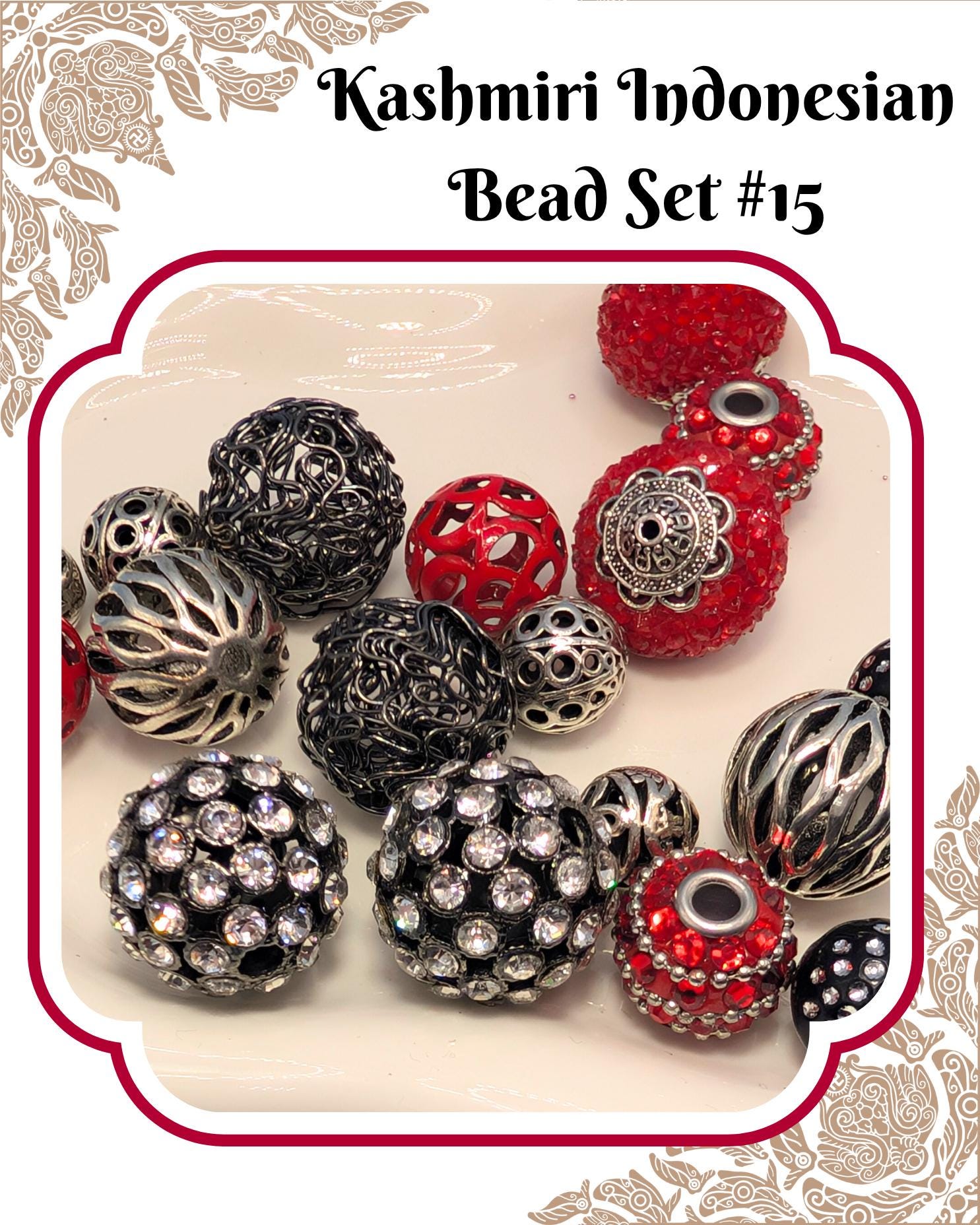 a collection of various beads, including black, silver, and red beads, arranged on a white background.