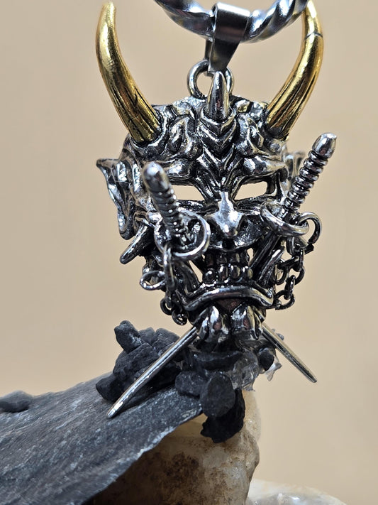 A close-up view of a metal sculpture with intricate details, including a pair of horns and various metallic elements.