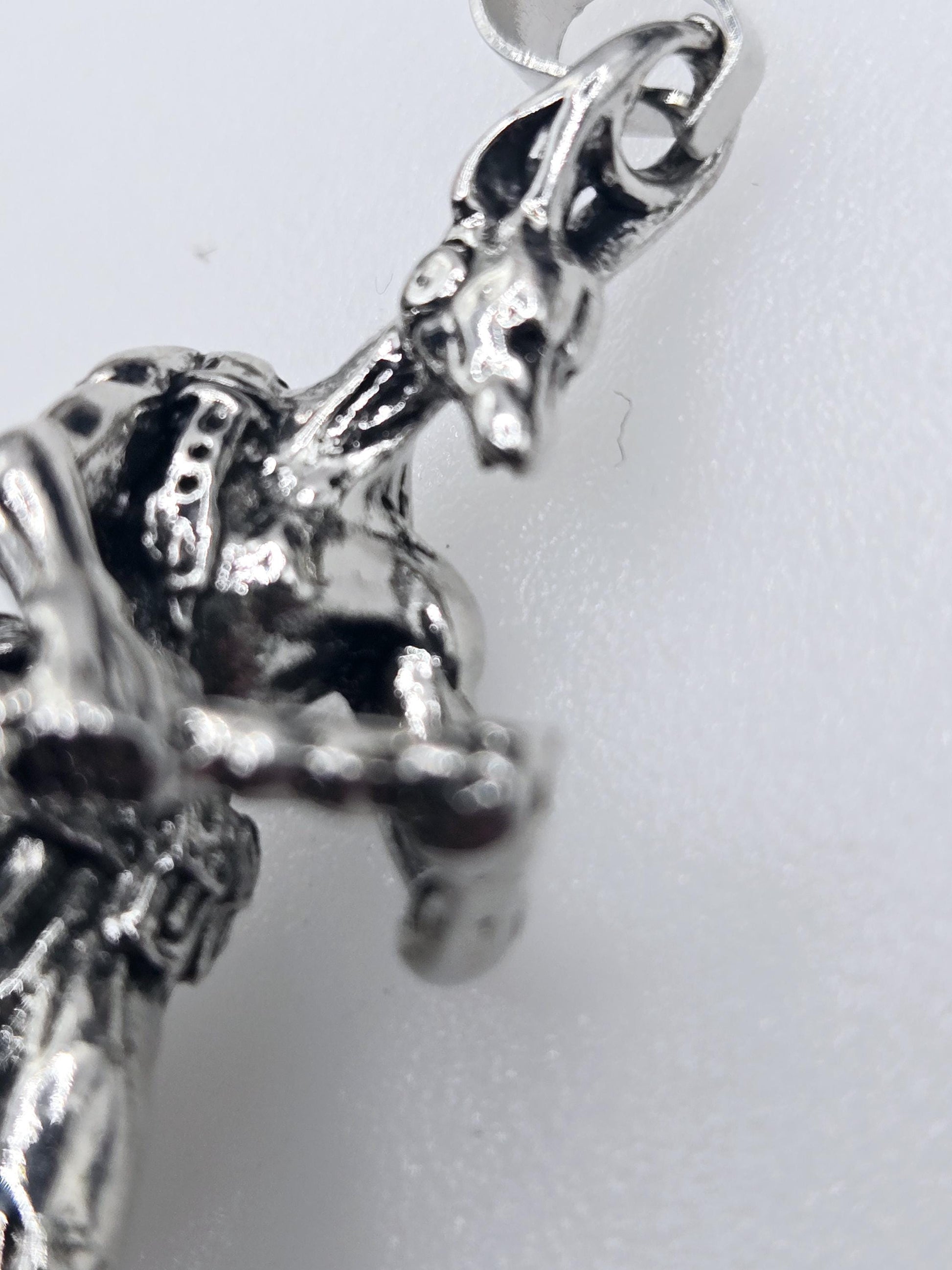A close-up view of a shiny, metallic object resembling a piece of jewelry or a decorative item.