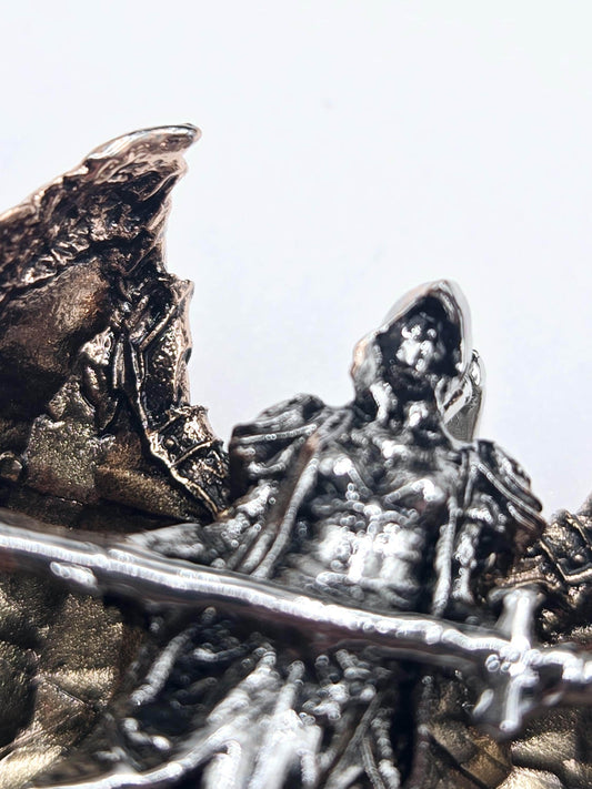 a close-up view of a metallic, textured surface with a metallic sheen. The surface appears to be a combination of metal and stone, with intricate patterns and textures visible. The image does not contain any text or other discernible objects or scenes.
