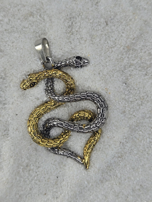 A pendant in the shape of a snake, with two snakes intertwined in a decorative pattern, is shown on a white surface.