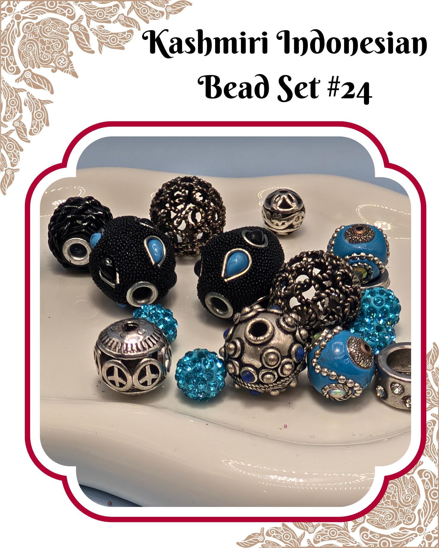 A collection of colorful beads, including black, blue, and silver beads, arranged on a white surface.