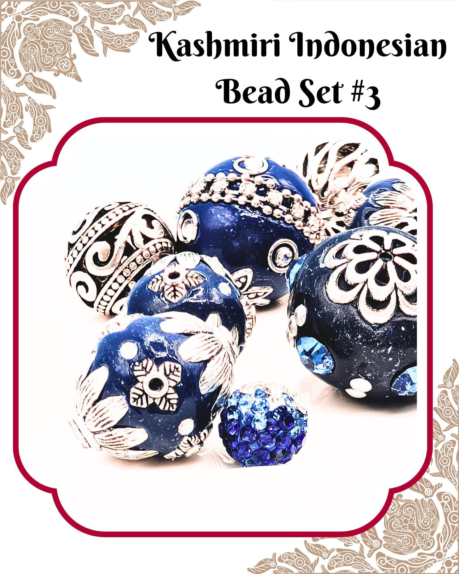 A collection of intricately designed blue and white beads, including a large blue bead surrounded by smaller blue and white beads, as well as a small blue bead with blue and white accents.