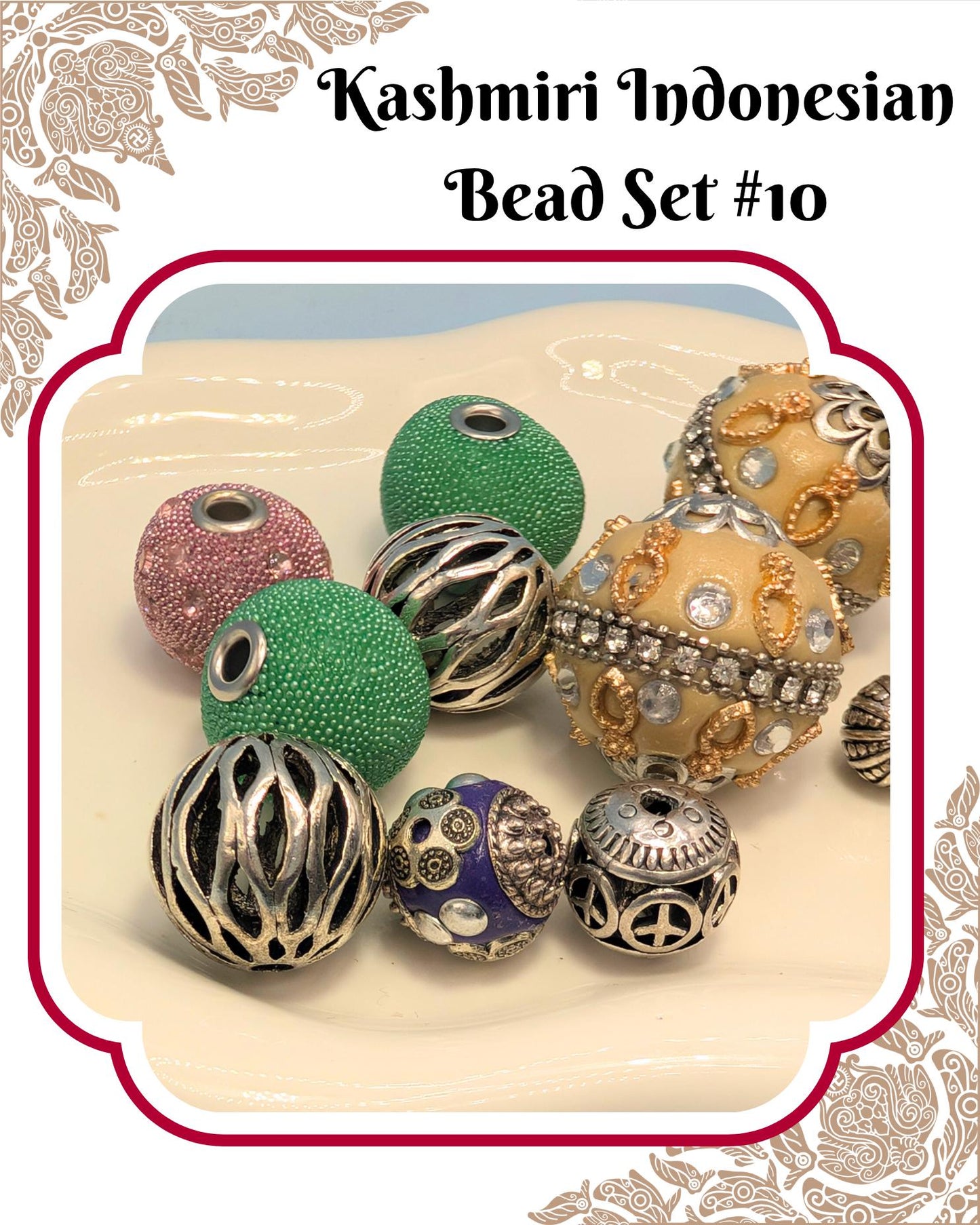 A collection of colorful beads, including green, silver, and gold-colored beads, arranged on a white surface.