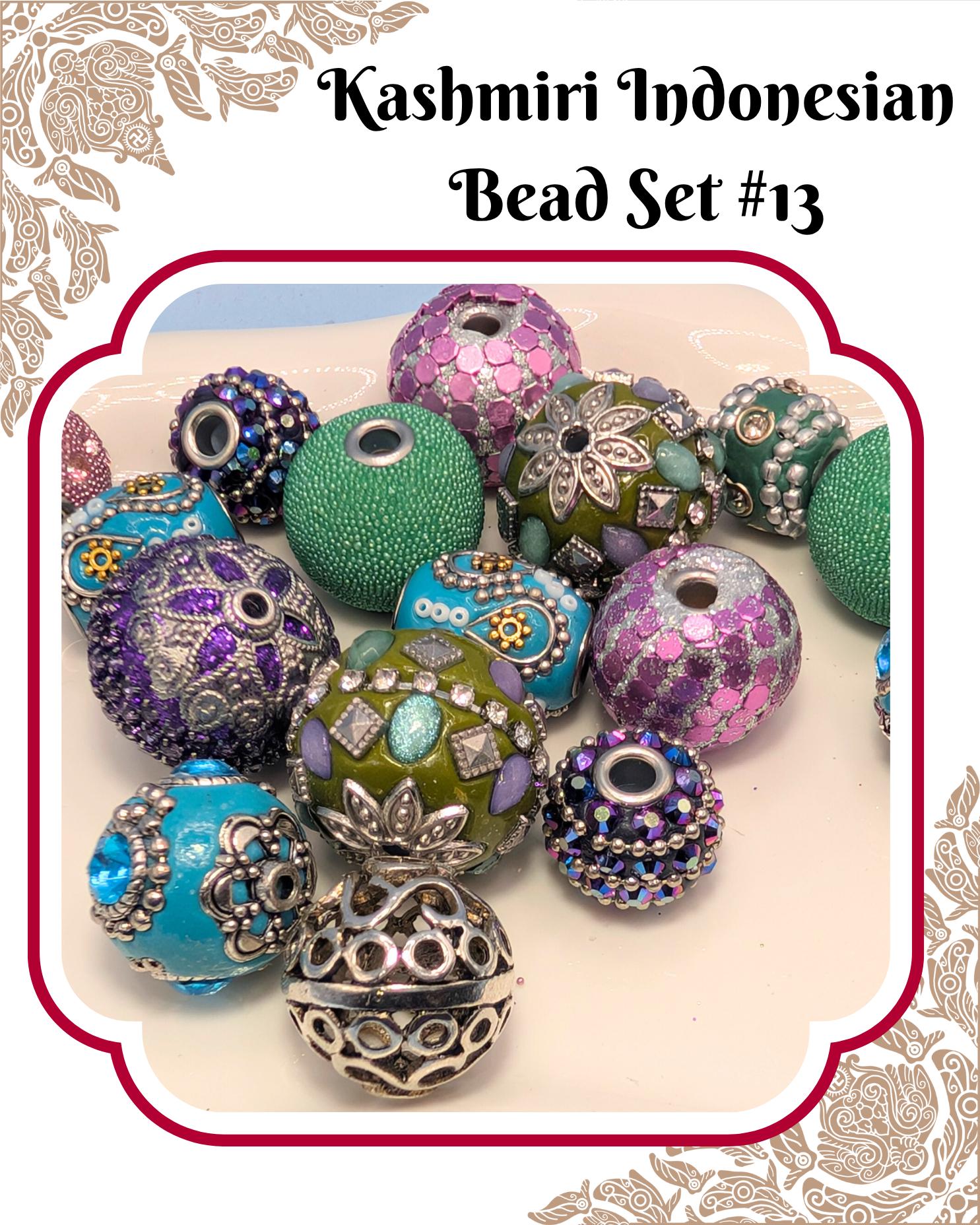 A collection of colorful beads, including green, purple, blue, and silver ones, arranged on a surface.