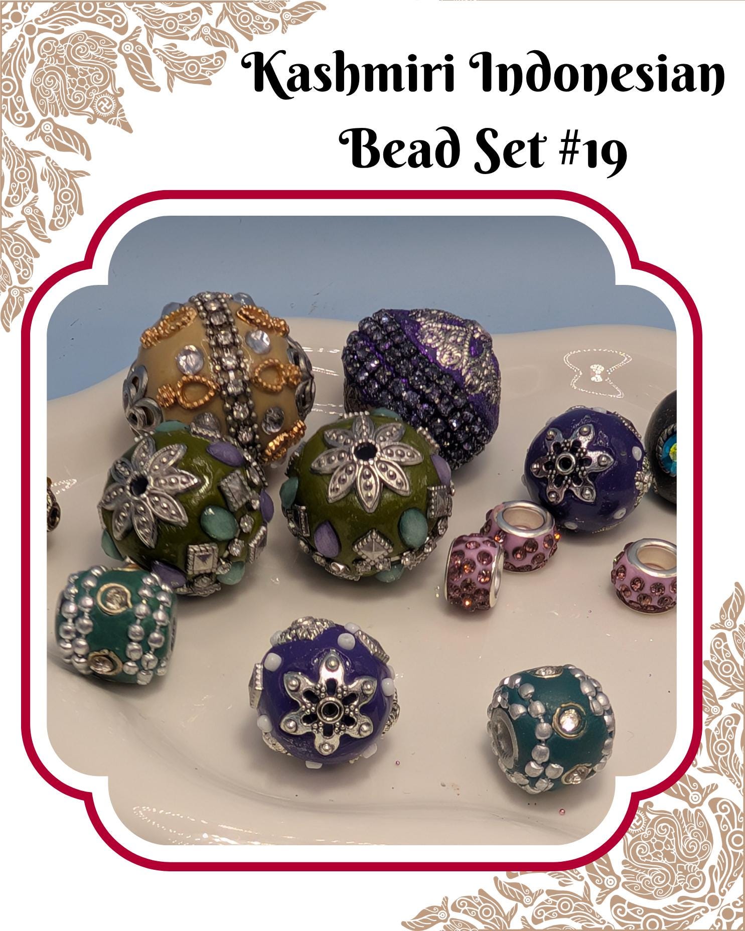 A collection of colorful, intricately designed beads in various shapes and sizes, including round, oval, and spherical pieces, arranged on a white surface.
