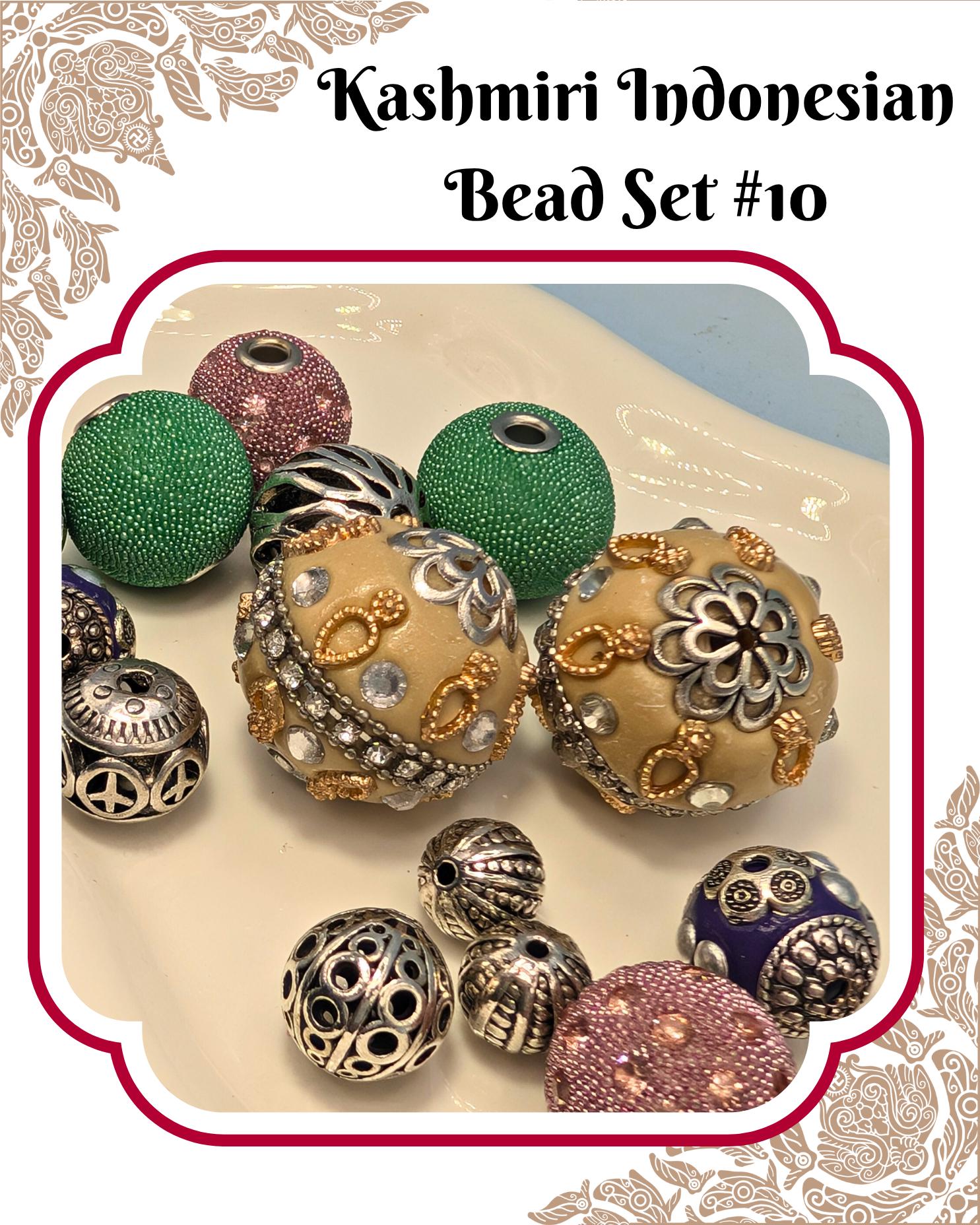 A collection of colorful beads, including green, gold, silver, and purple, arranged on a white surface.