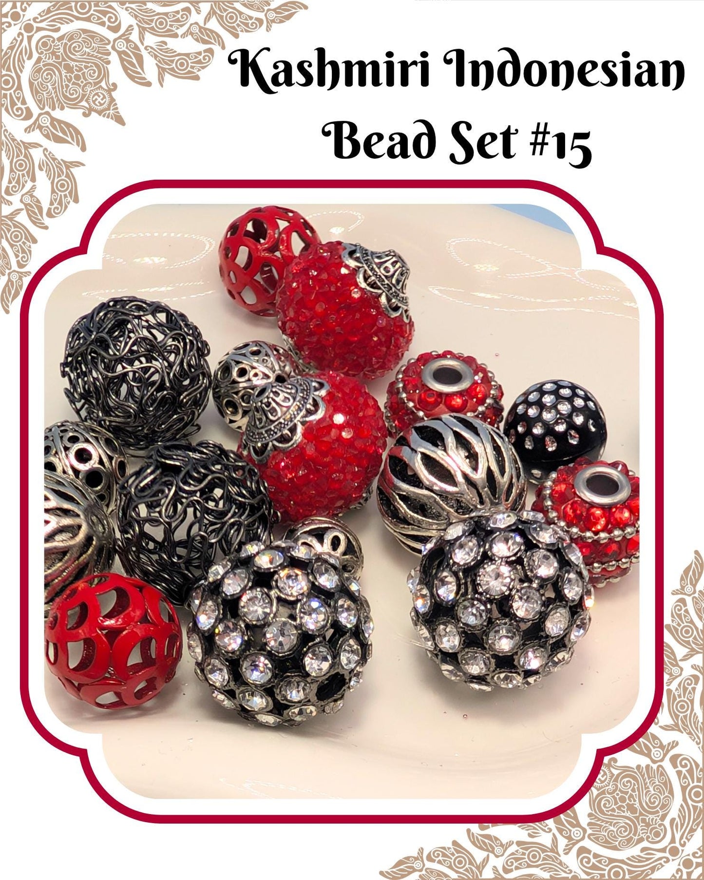 A collection of colorful beads, including red, silver, and black beads, arranged on a white surface.
