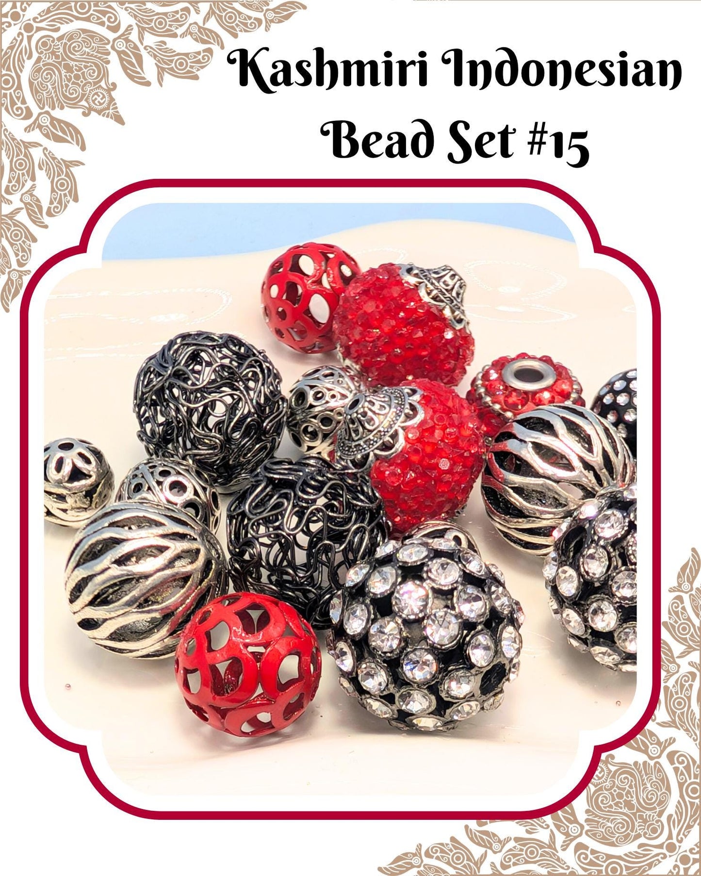 a collection of colorful beads, including red, black, silver, and crystal balls, arranged on a white surface.