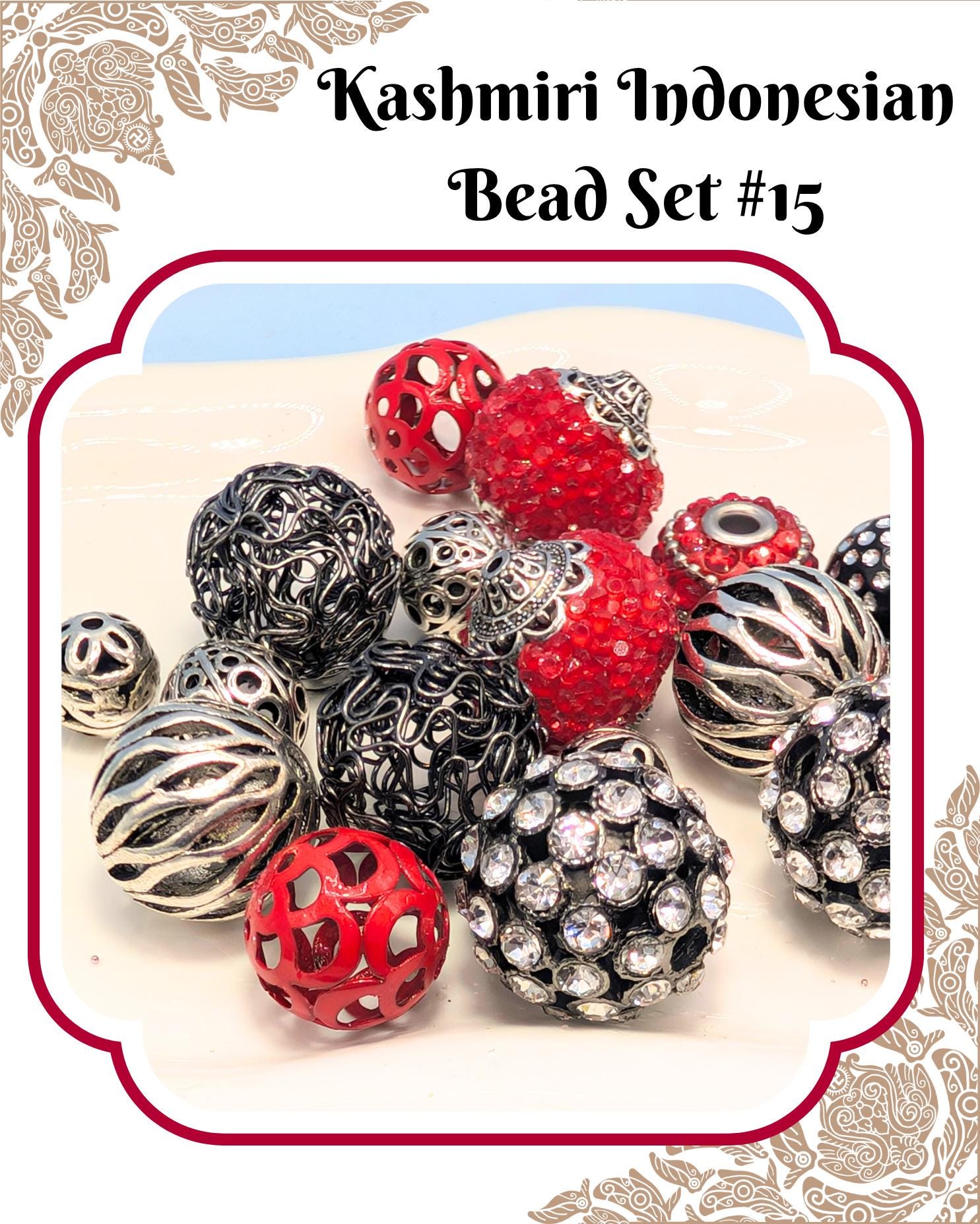 a collection of colorful beads, including red, black, silver, and crystal balls, arranged on a white surface.
