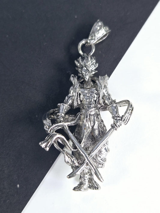 A silver-colored pendant or charm in the shape of a fish or sea creature, with intricate details and a metallic appearance.