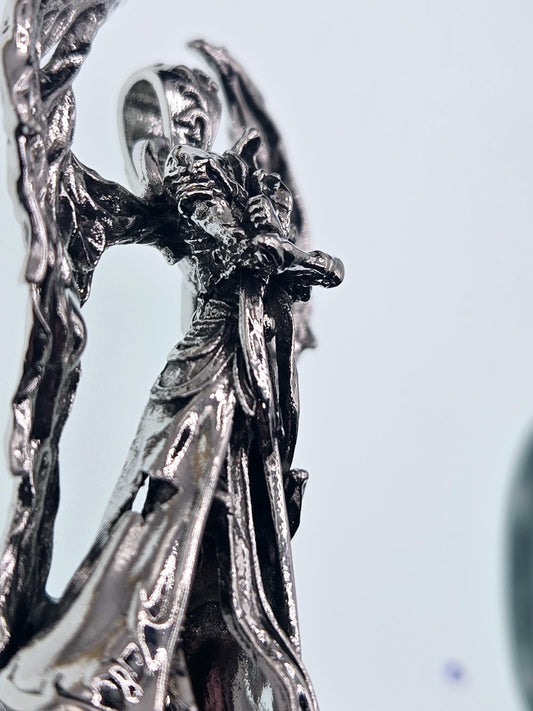 A close-up view of a shiny, metallic dragon sculpture with intricate details and textures.