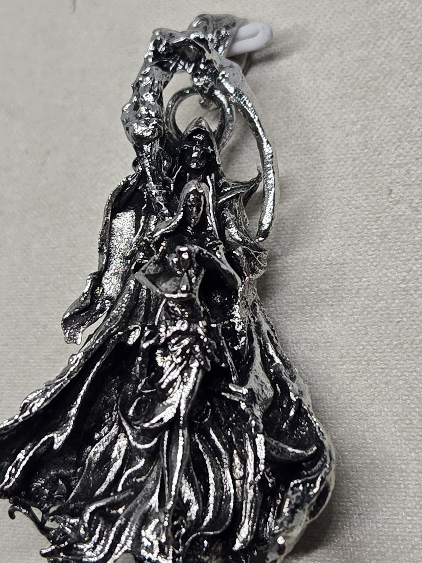 a close-up view of a metallic, sculptural object with a textured, organic appearance.