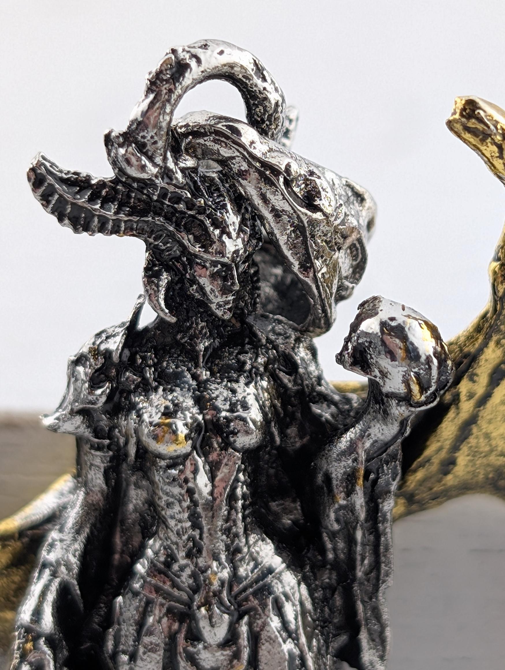 a detailed metal sculpture of a female figure with an intricate, textured design.