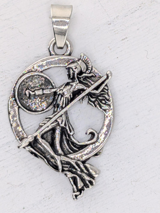 A silver-colored pendant featuring an intricate design of a woman holding a shield and a sword.
