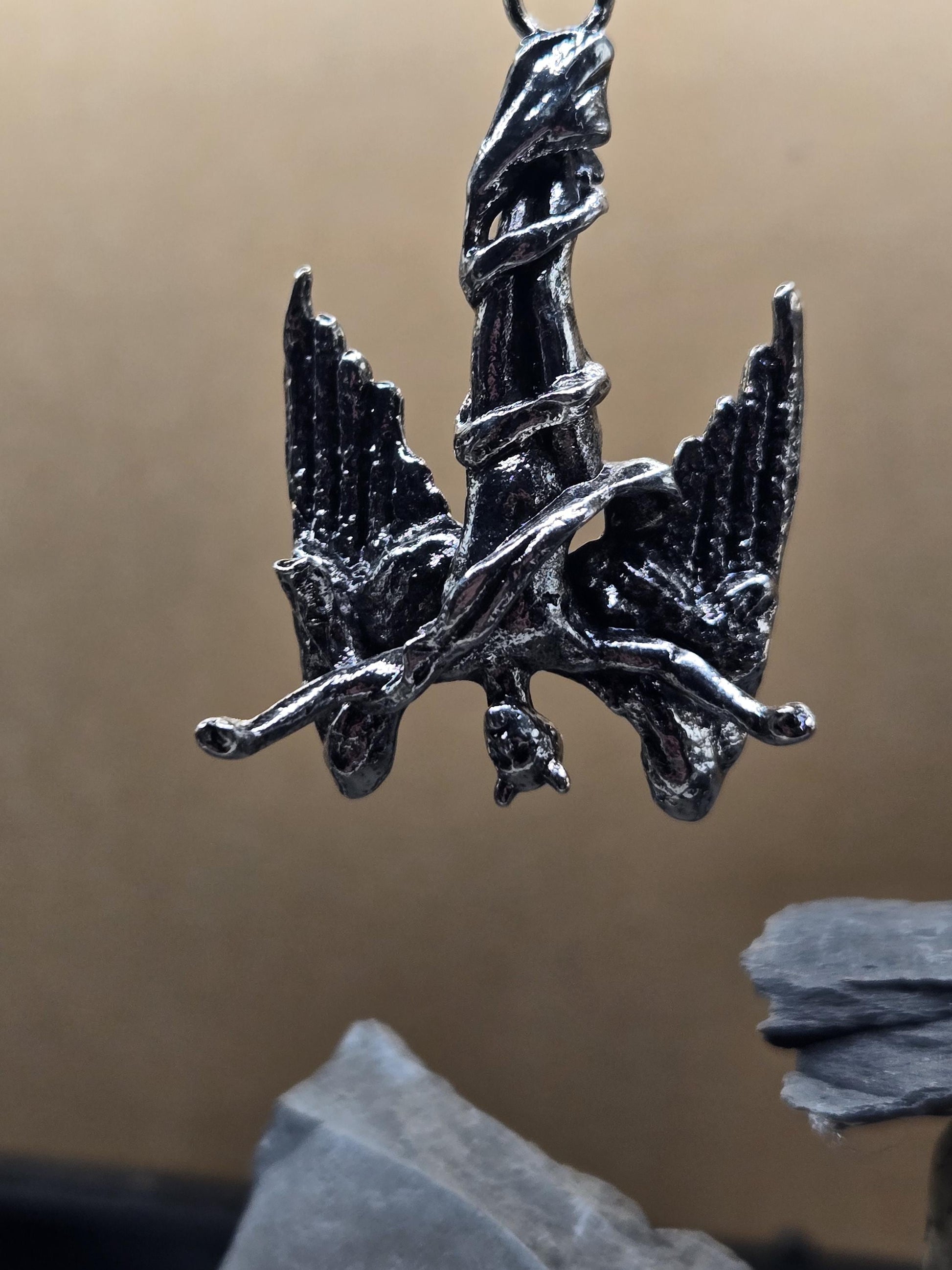 A close-up view of a metallic, winged sculpture with a detailed, sculpted design.