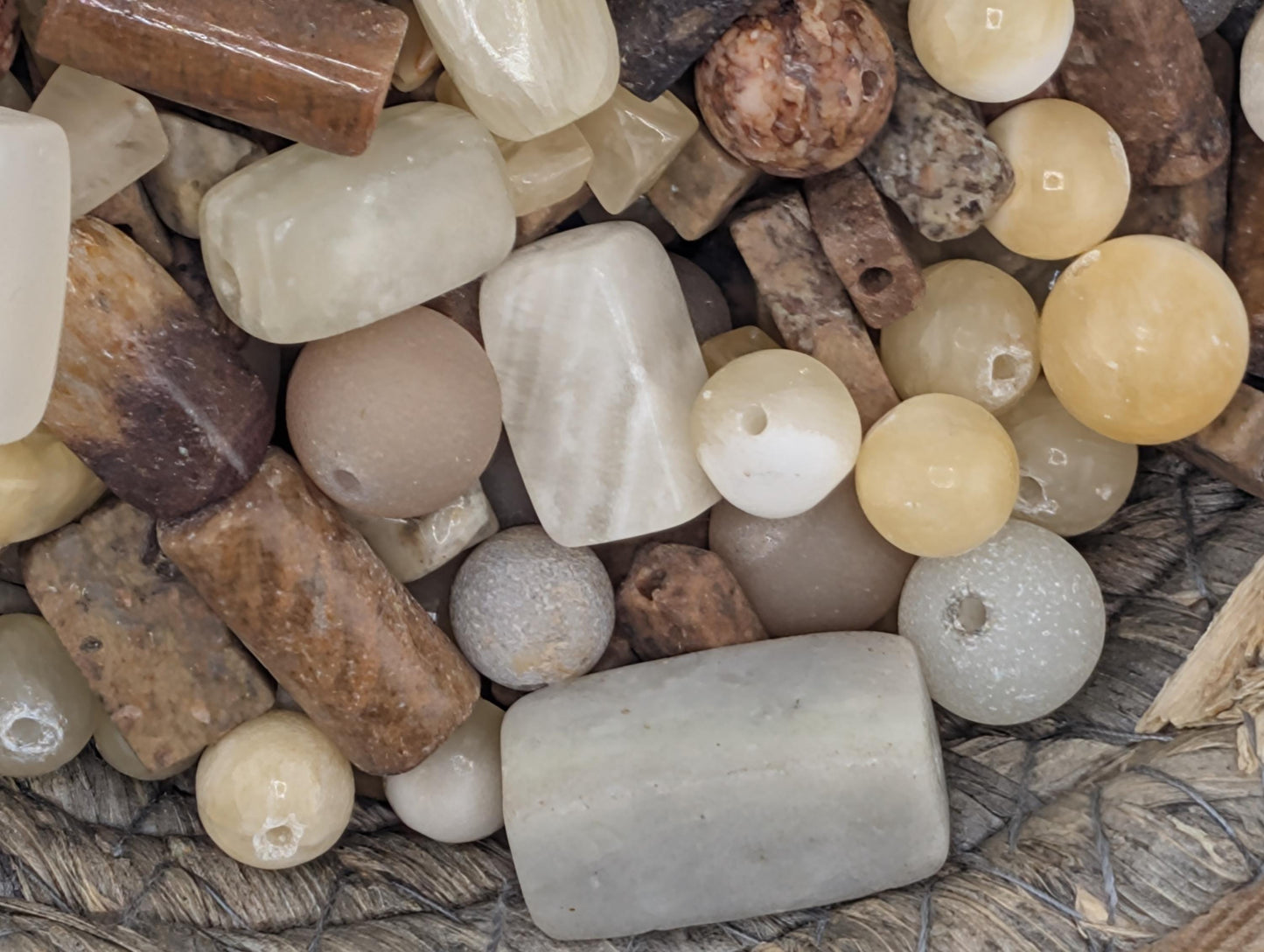 a collection of various natural objects, including beads, stones, and other minerals, arranged together.