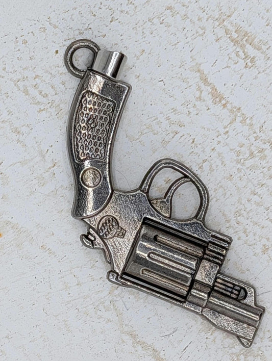 A silver-colored metal toy gun is shown against a white background.