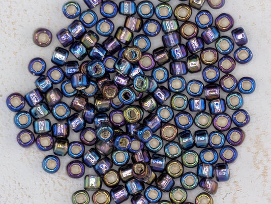5854SB Silver Lined Translucent Rainbow Purple Round With Square Hole 6/0 (15g Pkg)