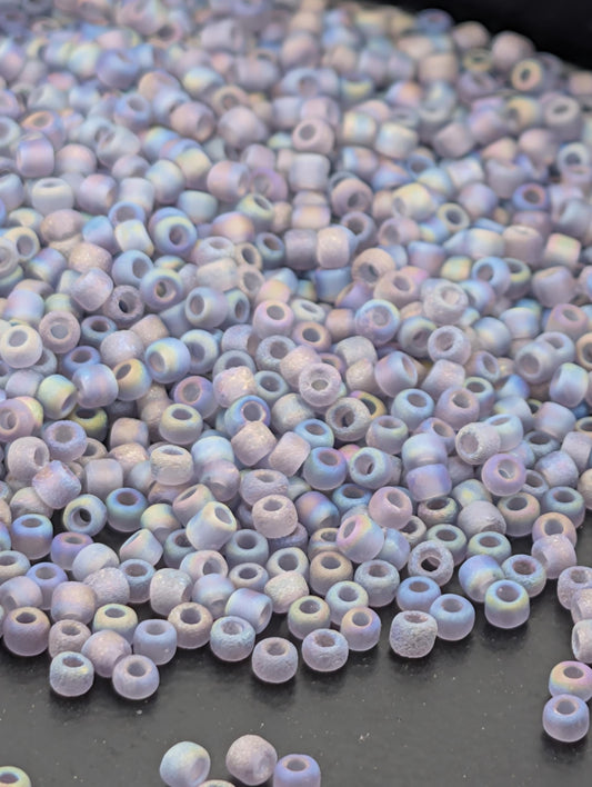 A pile of multicolored glass beads on a dark surface.