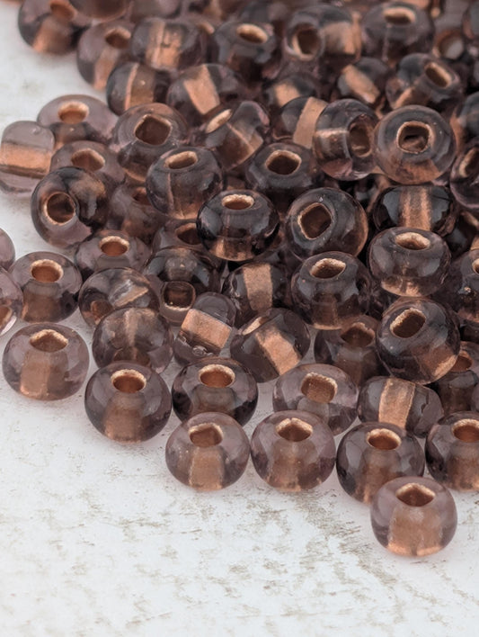 Transparent Copper-Lined Amethyst Size 11/0 15g pkg