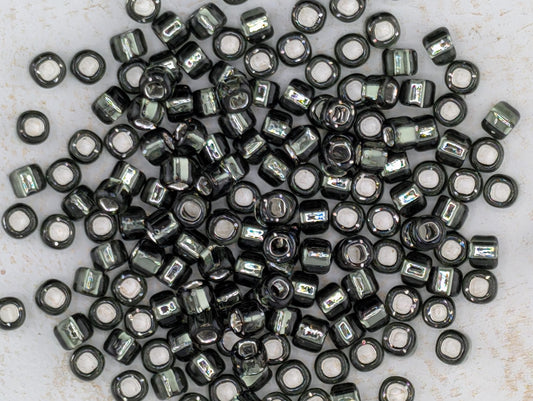 5167SB Silver Lined Translucent Gunmetal Round With Square Hole 6/0 (15g Pkg)