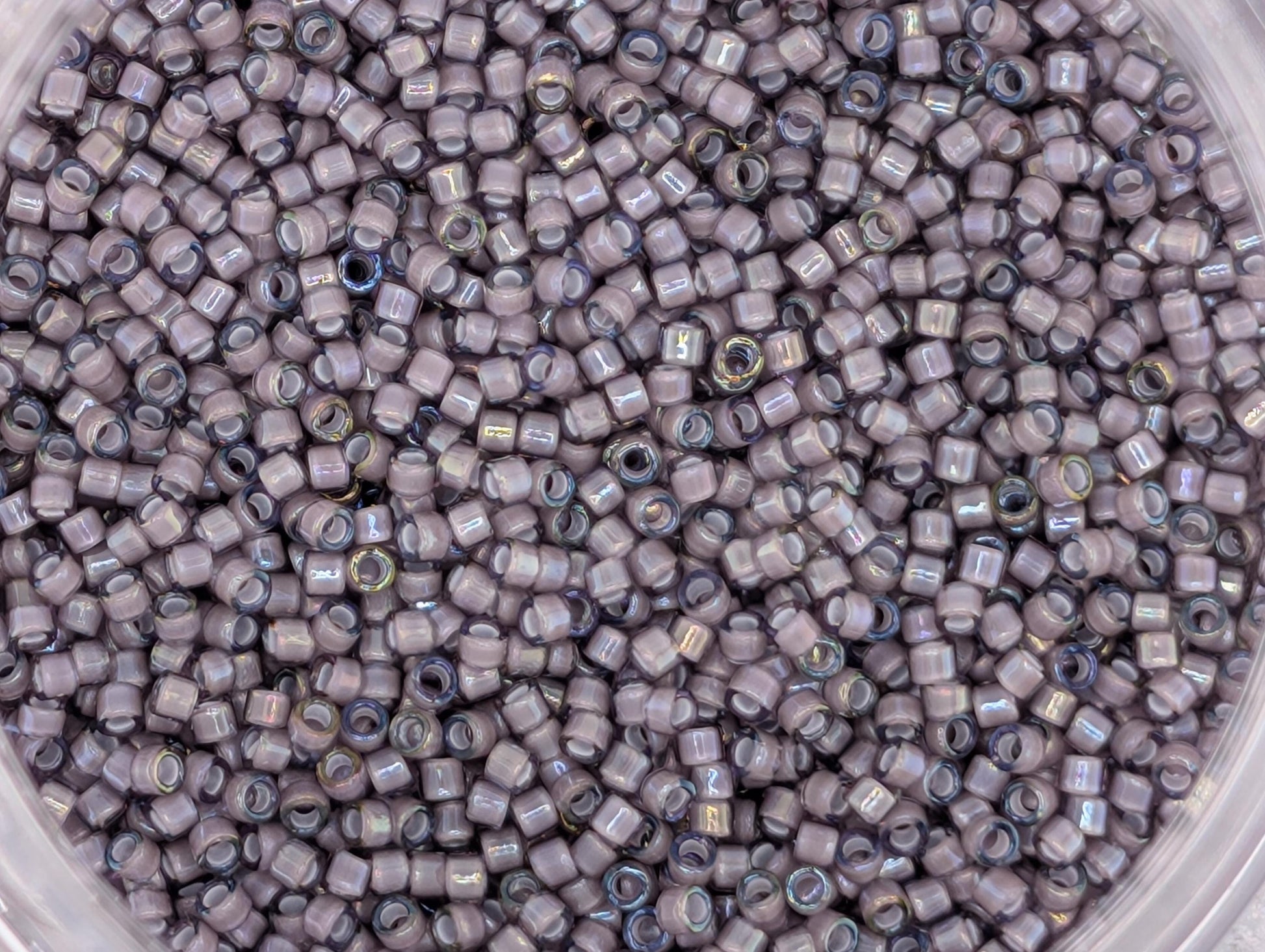 A close-up image of a large pile of small, round beads in various shades of gray.