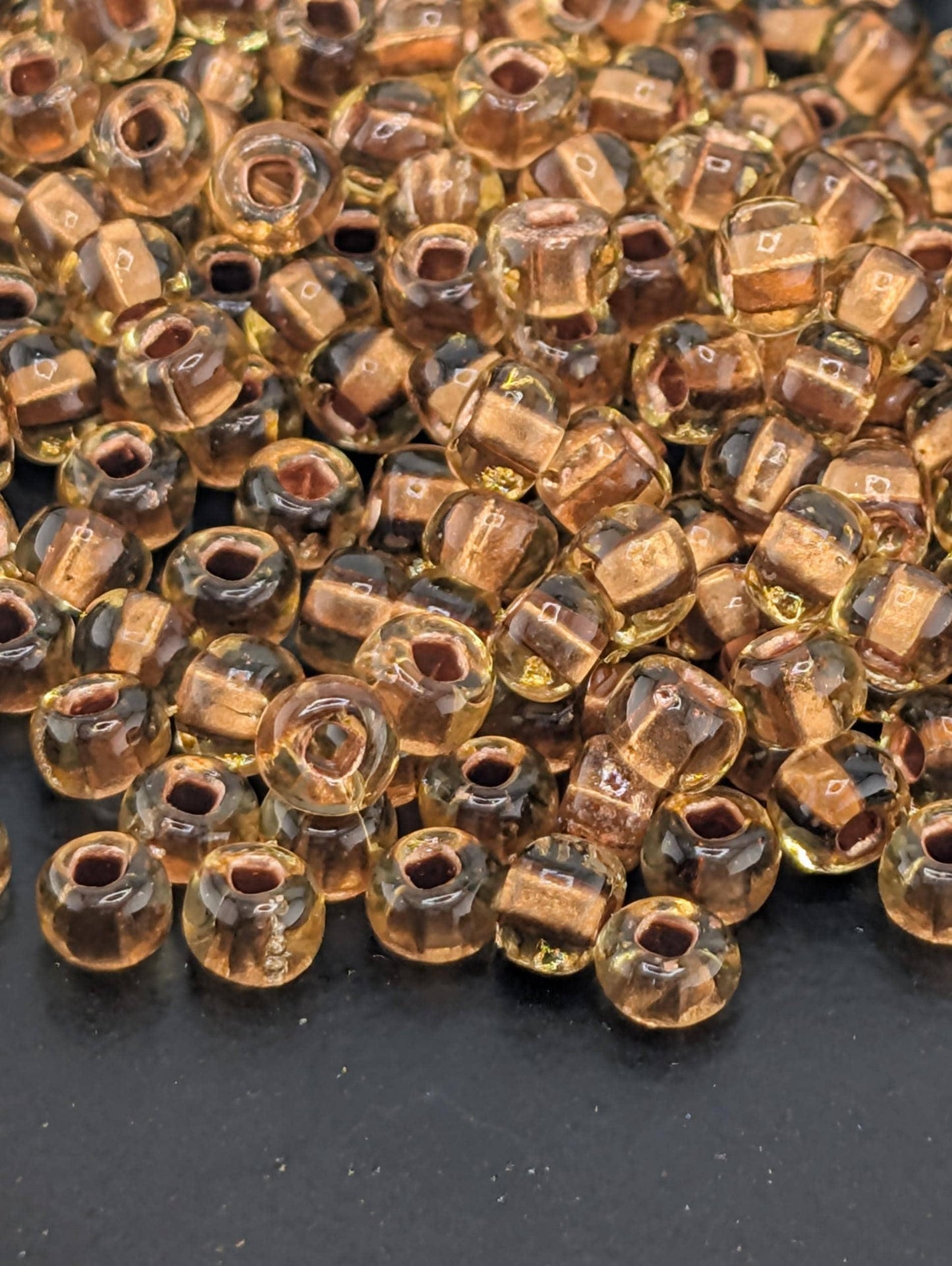 Preciosa 6/0 Rocaille, Translucent Color-Lined Copper Topaz. 15g pkg
