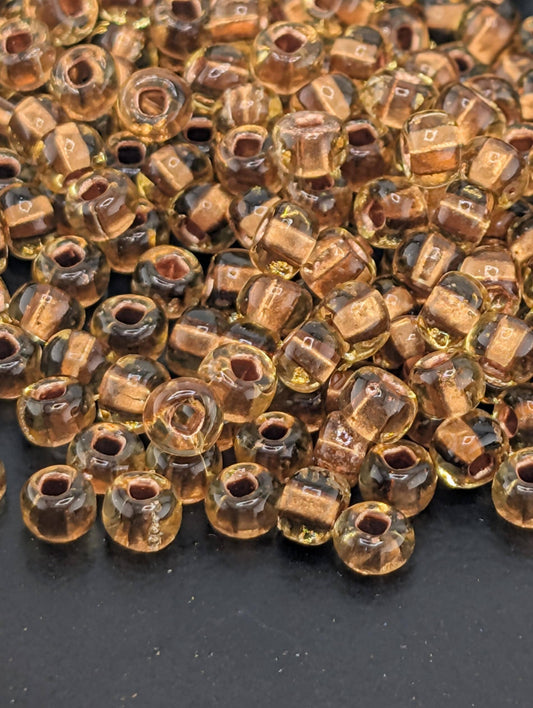 Preciosa 6/0 Rocaille, Translucent Color-Lined Copper Topaz. 15g pkg